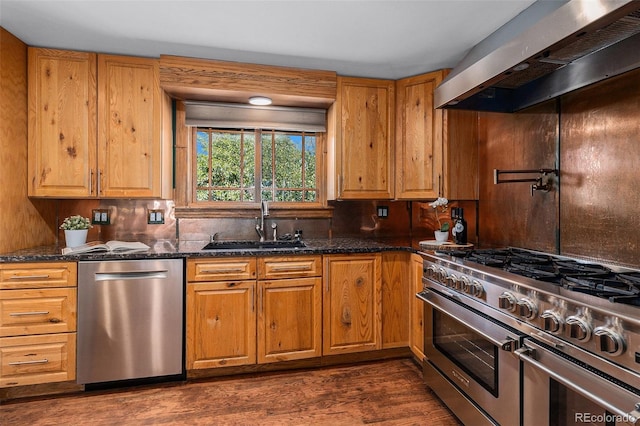 15 Pawnee Dr, Boulder, CO 80303 - kitchen featuring appliances with stainless steel finishes, ventilation hood, dark stone counters, dark wood finished floors, and brown cabinetry