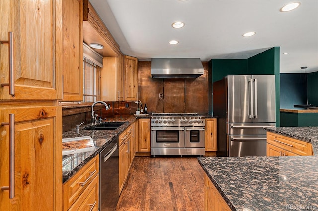 15 Pawnee Dr, Boulder, CO 80303 - kitchen featuring high end appliances, wall chimney range hood, dark wood-style floors, recessed lighting, and dark stone counters