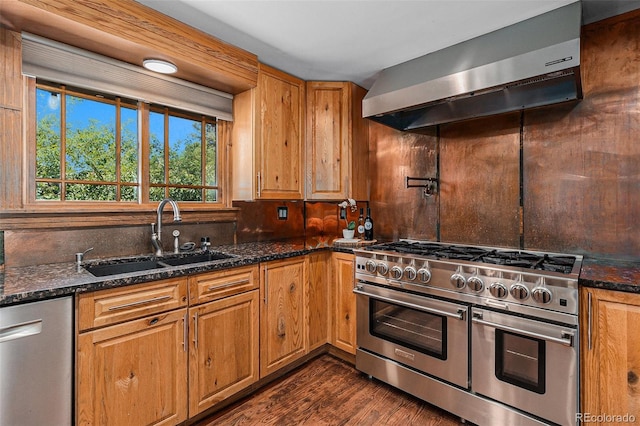 15 Pawnee Dr, Boulder, CO 80303 - kitchen featuring stainless steel appliances, wall chimney range hood, dark wood-style floors, dark stone counters, and brown cabinetry