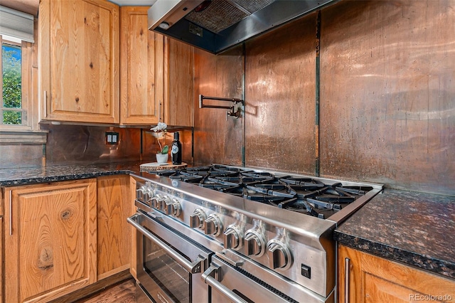 15 Pawnee Dr, Boulder, CO 80303 - kitchen with range with two ovens, extractor fan, decorative backsplash, dark stone counters, and wood finished floors