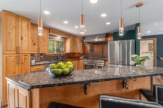 15 Pawnee Dr, Boulder, CO 80303 - kitchen with appliances with stainless steel finishes, wall chimney exhaust hood, a kitchen bar, recessed lighting, and hanging light fixtures