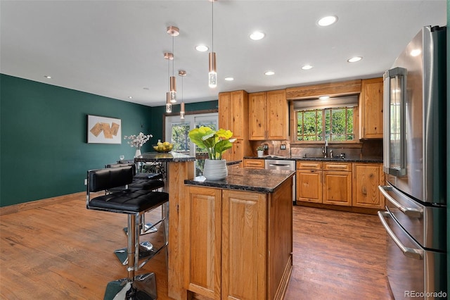 15 Pawnee Dr, Boulder, CO 80303 - kitchen featuring high end fridge, dark wood finished floors, recessed lighting, a center island, and a breakfast bar