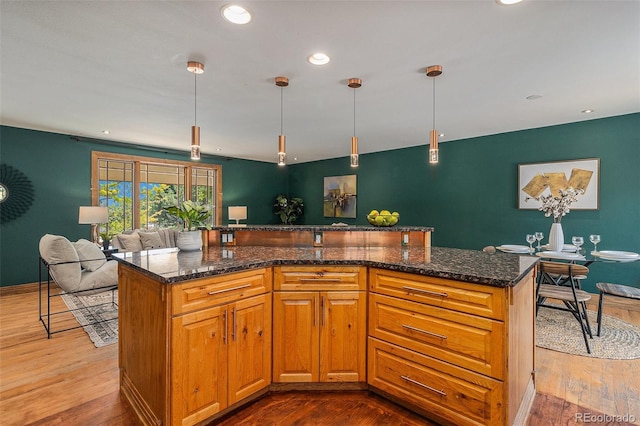15 Pawnee Dr, Boulder, CO 80303 - kitchen featuring dark wood finished floors, decorative light fixtures, dark stone counters, and recessed lighting
