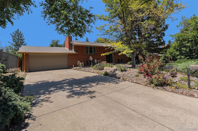 15 Pawnee Dr, Boulder, CO 80303 - ranch-style house featuring a garage, driveway, brick siding, and a chimney
