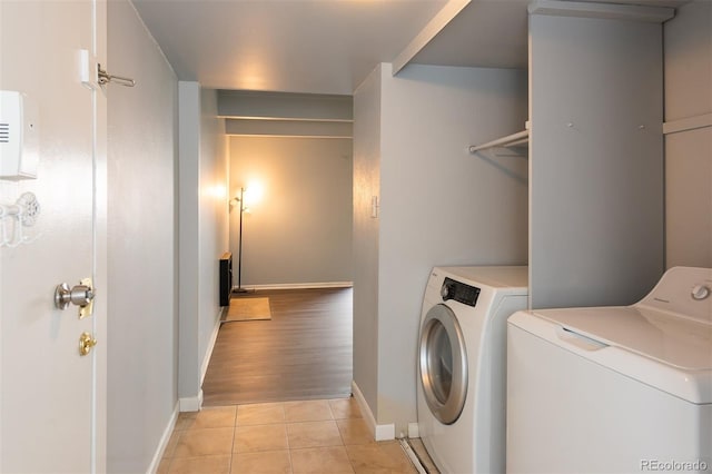 laundry area featuring light hardwood / wood-style floors and washing machine and dryer