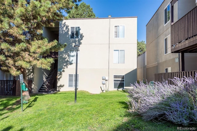 rear view of house featuring a lawn