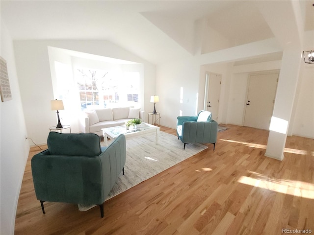 living room featuring vaulted ceiling and light wood-style flooring