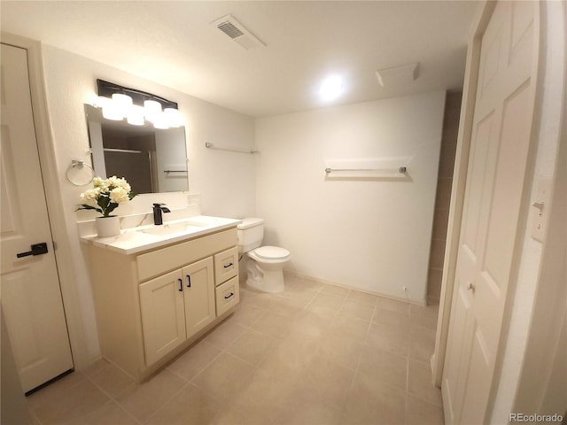 bathroom featuring vanity, toilet, a shower, and visible vents