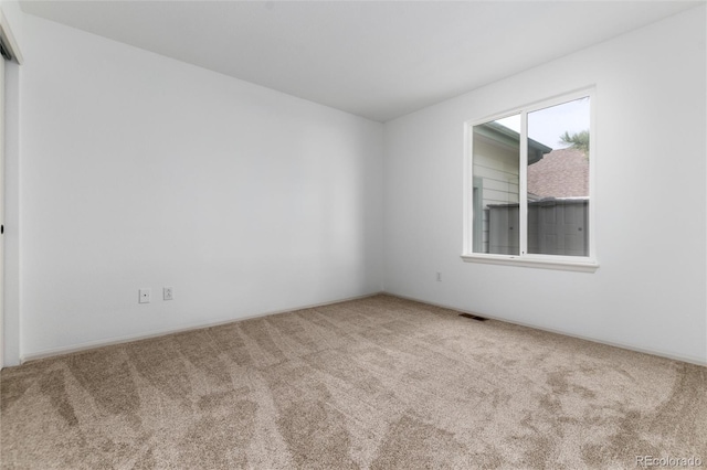 carpeted empty room with visible vents