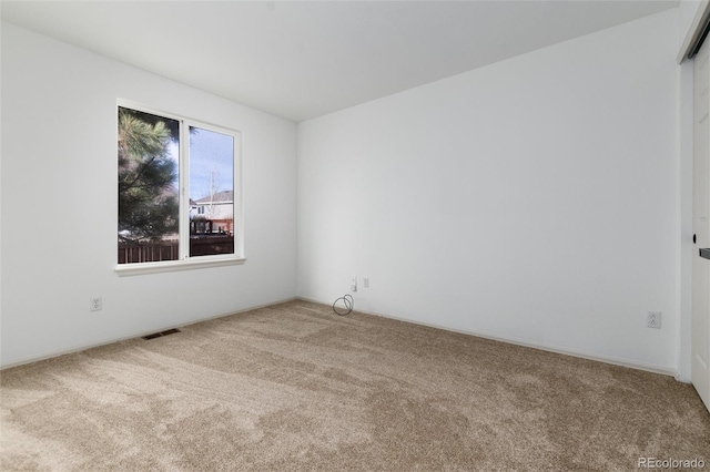 spare room featuring carpet and visible vents