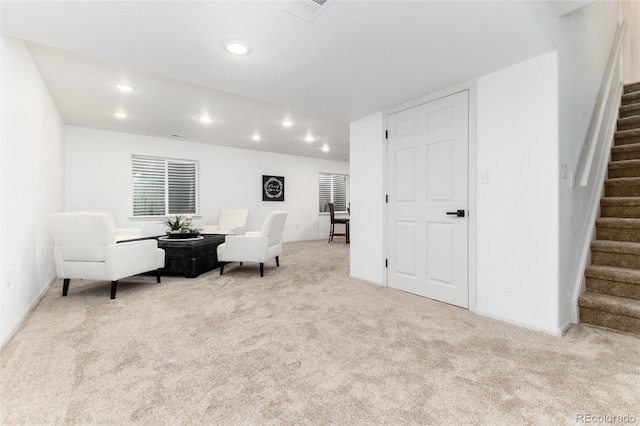 sitting room with recessed lighting, visible vents, carpet, and stairs