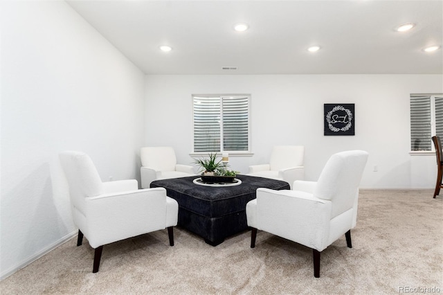 sitting room with recessed lighting, light colored carpet, and visible vents