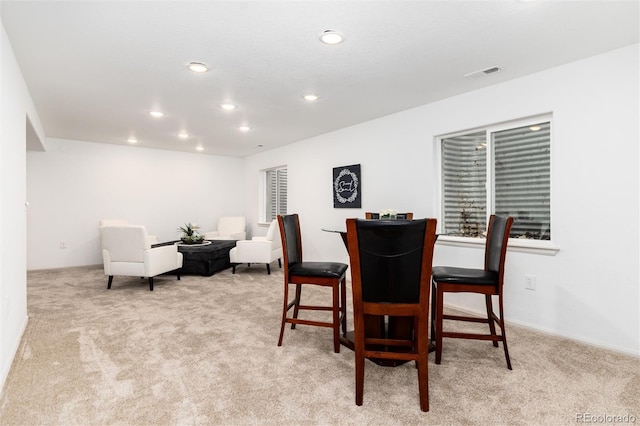 dining room featuring recessed lighting, light colored carpet, and visible vents