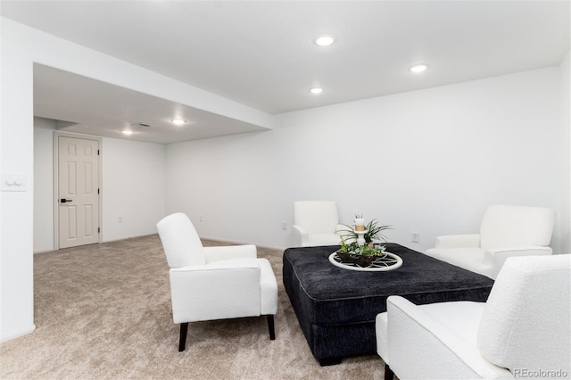 sitting room with recessed lighting and light colored carpet