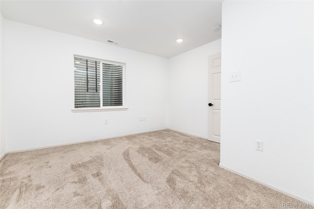 empty room with recessed lighting, visible vents, and carpet