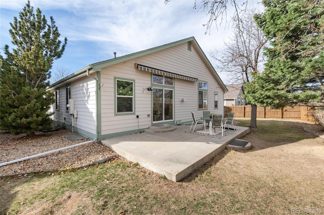 back of property featuring entry steps, a patio, and fence