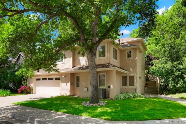 5530 Racquet Ln, Boulder, CO 80303 - view of front of house with driveway, a front lawn, stucco siding, an attached garage, and a shingled roof