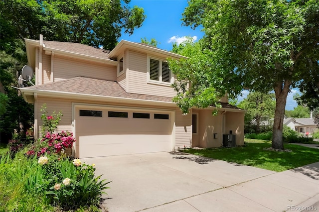 5530 Racquet Ln, Boulder, CO 80303 - view of front of home with concrete driveway, roof with shingles, a front yard, and a garage