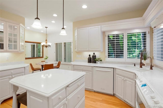 5530 Racquet Ln, Boulder, CO 80303 - kitchen with white dishwasher, stove, white cabinets, recessed lighting, and light wood-style flooring