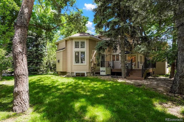 5530 Racquet Ln, Boulder, CO 80303 - back of property with a lawn and a wooden deck