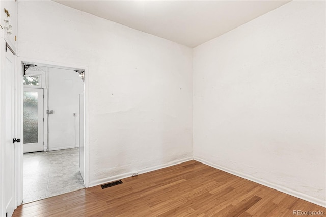 empty room with hardwood / wood-style flooring