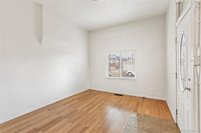 unfurnished room with hardwood / wood-style flooring