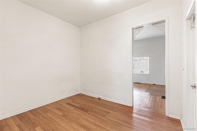 spare room with hardwood / wood-style floors