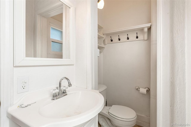 bathroom featuring toilet and sink