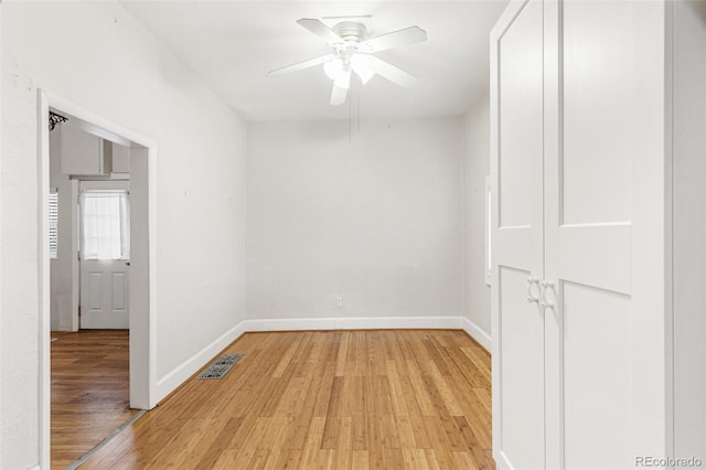 unfurnished room with ceiling fan and light wood-type flooring