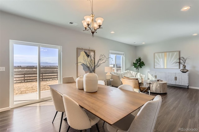 dining room with a chandelier and dark hardwood / wood-style flooring