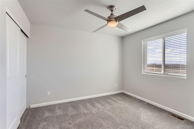 unfurnished bedroom with carpet floors, ceiling fan, and a closet