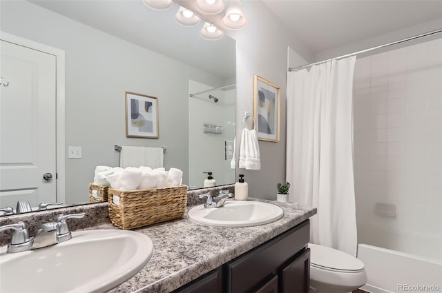 full bathroom featuring vanity, toilet, and shower / tub combo