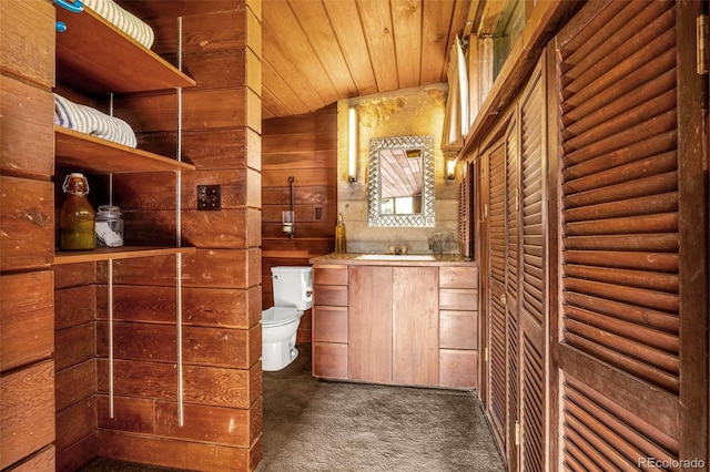 1455 La Mesa St, Colorado Springs, CO 80904 - bathroom with toilet, vanity, wooden ceiling, and wooden walls