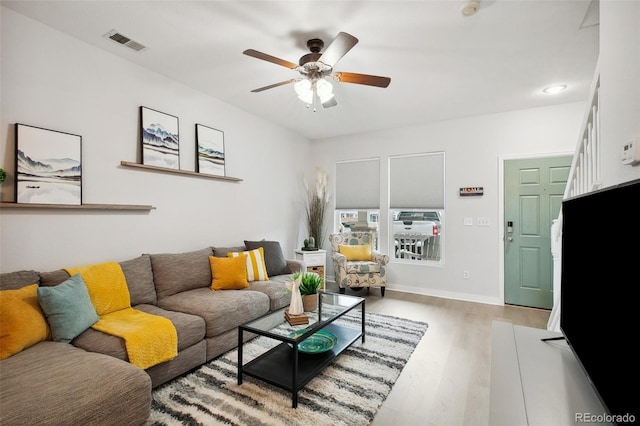 living room with ceiling fan and light wood-type flooring