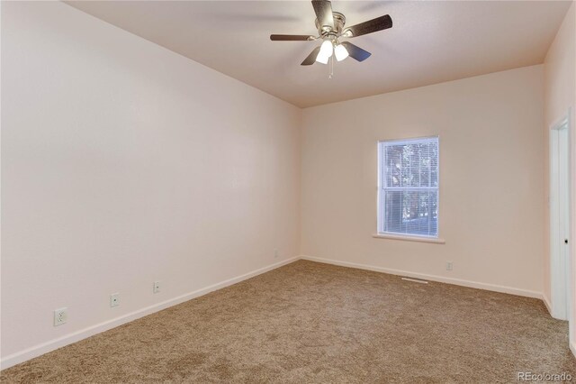 carpeted spare room with ceiling fan