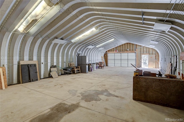 miscellaneous room featuring concrete floors and vaulted ceiling