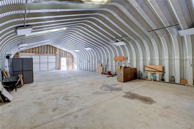 miscellaneous room featuring lofted ceiling and concrete flooring