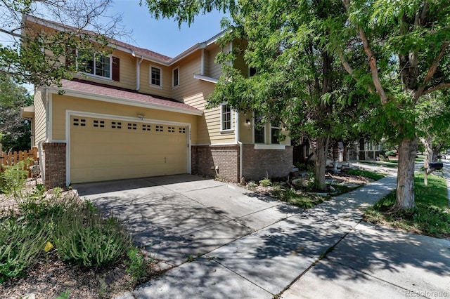 10609 Abilene St, Commerce City, CO 80022 - view of front of house featuring brick siding, concrete driveway, and a garage