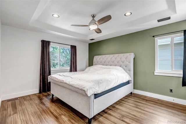 10609 Abilene St, Commerce City, CO 80022 - bedroom with a tray ceiling, wood finished floors, recessed lighting, and a ceiling fan