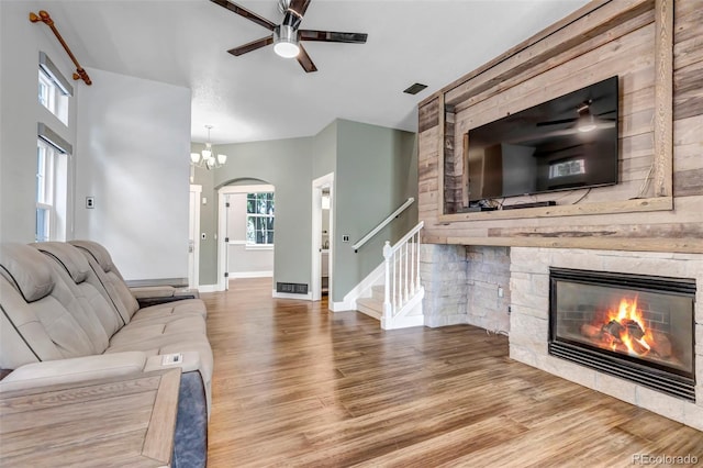 10609 Abilene St, Commerce City, CO 80022 - living area with ceiling fan, wood finished floors, a fireplace, and arched walkways