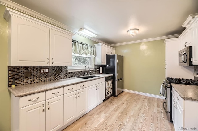 6072 Pierson Ct, Arvada, CO 80004 - kitchen featuring stainless steel appliances, tasteful backsplash, light wood-type flooring, white cabinets, and crown molding