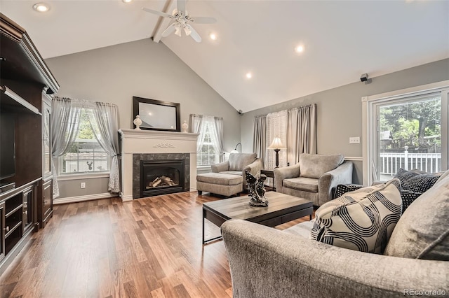 6072 Pierson Ct, Arvada, CO 80004 - living area featuring a ceiling fan, beamed ceiling, wood finished floors, a premium fireplace, and high vaulted ceiling