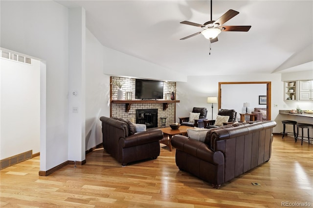 3298 S Krameria St, Denver, CO 80222 - living area with lofted ceiling, a brick fireplace, light wood-type flooring, and ceiling fan
