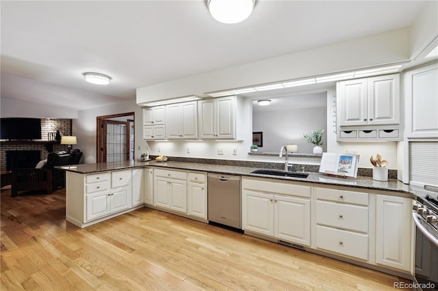 3298 S Krameria St, Denver, CO 80222 - kitchen featuring stainless steel appliances, a peninsula, white cabinetry, light wood finished floors, and dark stone counters