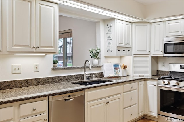 3298 S Krameria St, Denver, CO 80222 - kitchen featuring stainless steel appliances, white cabinets, and dark stone countertops
