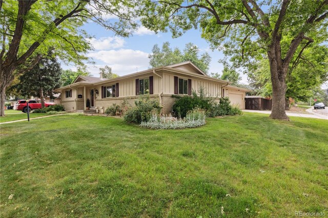 3298 S Krameria St, Denver, CO 80222 - ranch-style home featuring a garage, brick siding, a front lawn, and board and batten siding