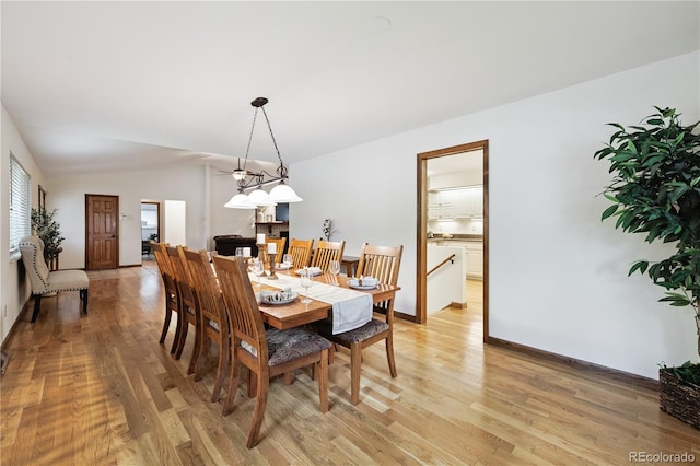 3298 S Krameria St, Denver, CO 80222 - dining space with light wood-style flooring and baseboards