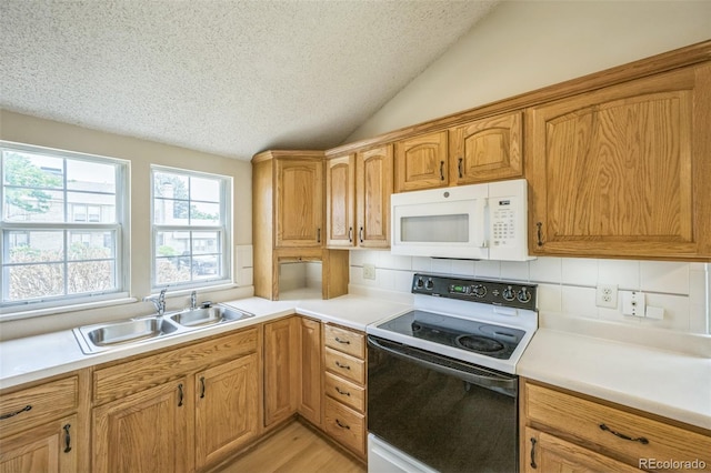 9642 W Chatfield Ave Unit A, Littleton, CO 80128 - kitchen featuring white microwave, electric range, a textured ceiling, vaulted ceiling, and light countertops