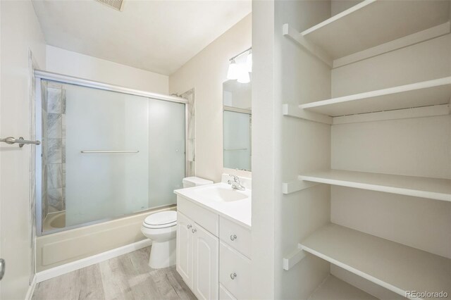 9642 W Chatfield Ave Unit A, Littleton, CO 80128 - full bath featuring vanity, shower / bath combination with glass door, and wood finished floors