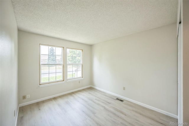 9642 W Chatfield Ave Unit A, Littleton, CO 80128 - empty room featuring light wood-type flooring and a textured ceiling